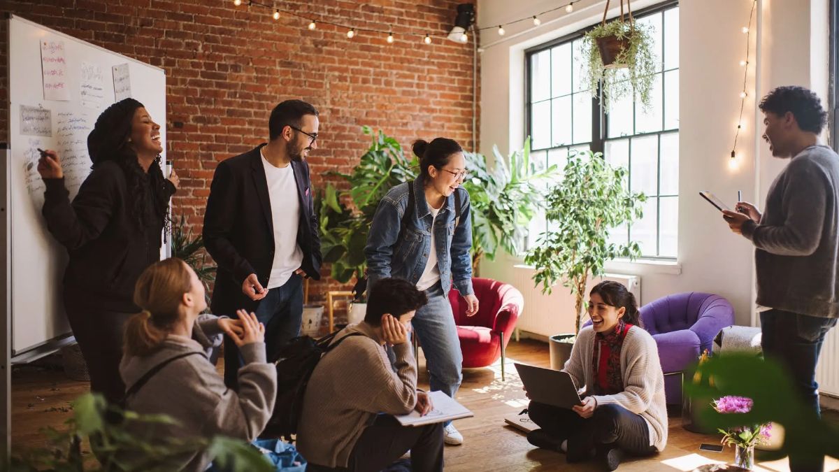 Founders and talent gathered in a brick loft, talking in small groups